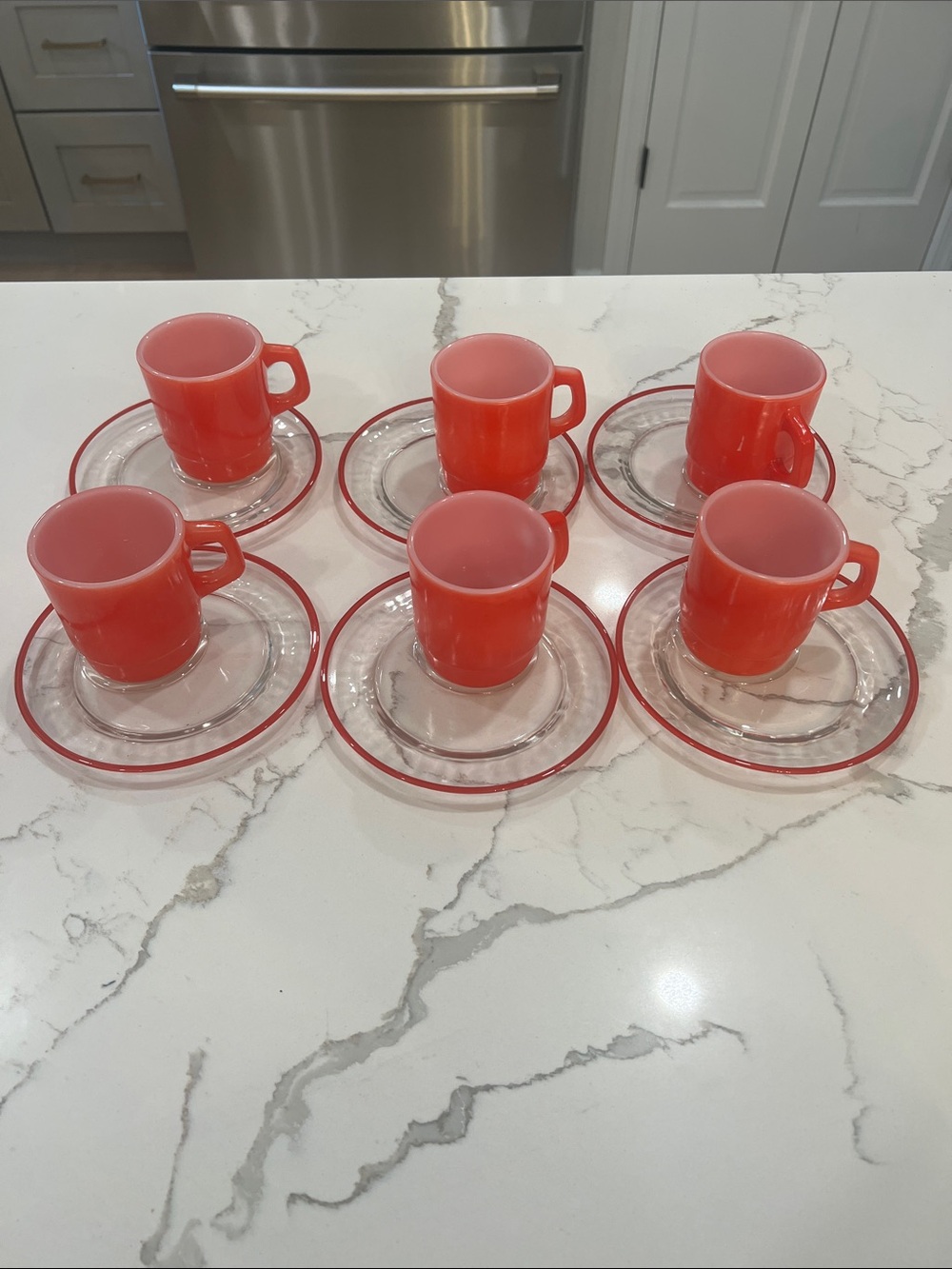 Vintage Set of 6 Fire King Red Milk Glass Mugs with Clear snack dishes.